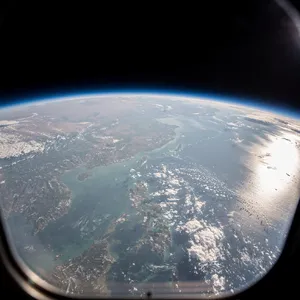 Photorealistic aerial photograph clearly showing the edge of the Earth from space, capturing realistic curvature, atmosphere, and sunlight reflections - Black Forest Labs FLUX.2 Max