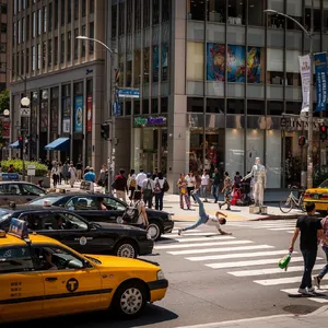 A busy city intersection with cars, pedestrians, and street performers all in one frame. - Black Forest Labs Flux 2 Pro