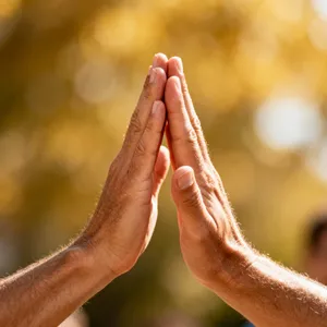 Two people high-fiving, with focus on their hands meeting mid-air. - Bytedance Seedream 4.0