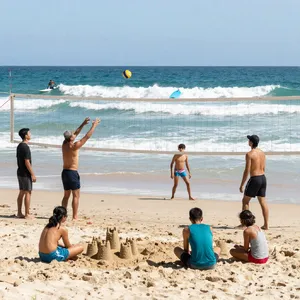 A beach scene: adults playing volleyball, kids building sandcastles, and surfers riding waves. - Alibaba Z-Image Turbo