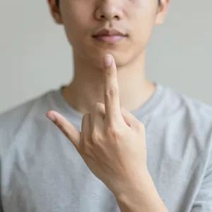 Photorealistic close-up portrait of a person clearly performing the American Sign Language gesture for 