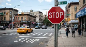 A red stop sign on a street corner displaying the word 