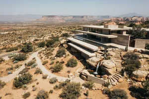 Aerial view of a modernist desert home, in the style of Frank Lloyd Wright's Fallingwater but adapted to desert conditions. Show integration with rocky landscape and water features. - Ideogram Ideogram 4.0 (Quality)
