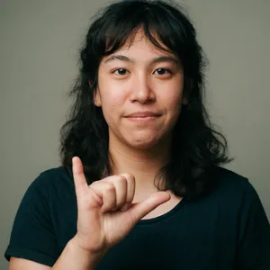 Photorealistic close-up portrait of a person clearly performing the American Sign Language gesture for 