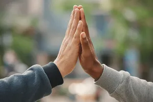 Two people high-fiving, with focus on their hands meeting mid-air. - XAI Grok Imagine 2.0 (Preview)