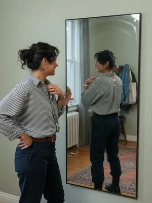 A person standing before a mirror, with their front and reflected back both visible. - XAI Grok Imagine (Quality)