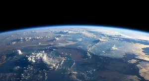 Photorealistic aerial photograph clearly showing the edge of the Earth from space, capturing realistic curvature, atmosphere, and sunlight reflections - XAI Grok Imagine